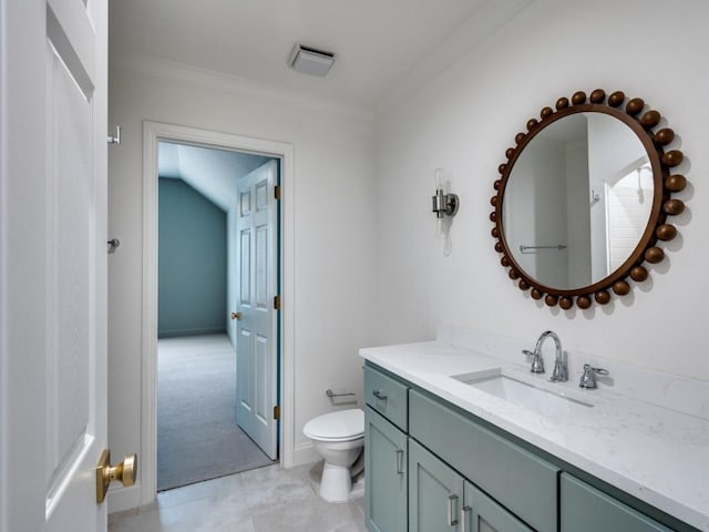 bathroom featuring toilet, ornamental molding, and vanity