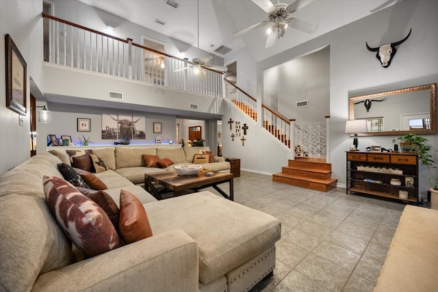 2608 Rivercrest Dr, Arlington, TX 76006 - living room featuring a towering ceiling, a ceiling fan, stairs, and baseboards
