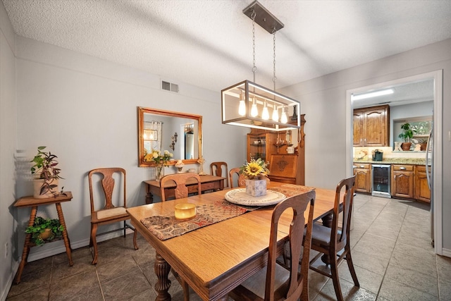 2608 Rivercrest Dr, Arlington, TX 76006 - dining area featuring wine cooler, bar, and light tile patterned flooring