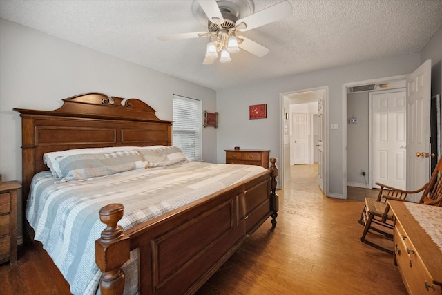 2608 Rivercrest Dr, Arlington, TX 76006 - bedroom with wood finished floors, a textured ceiling, and ceiling fan