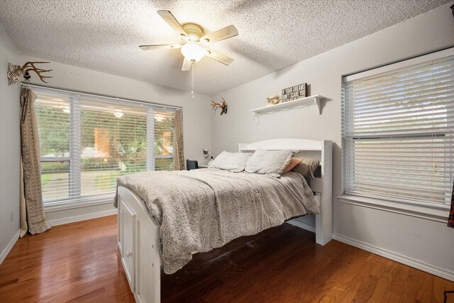 2608 Rivercrest Dr, Arlington, TX 76006 - bedroom with a textured ceiling, wood finished floors, baseboards, and a ceiling fan