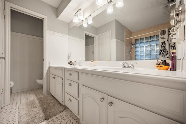 2608 Rivercrest Dr, Arlington, TX 76006 - bathroom featuring toilet, double vanity, tile patterned floors, and a shower