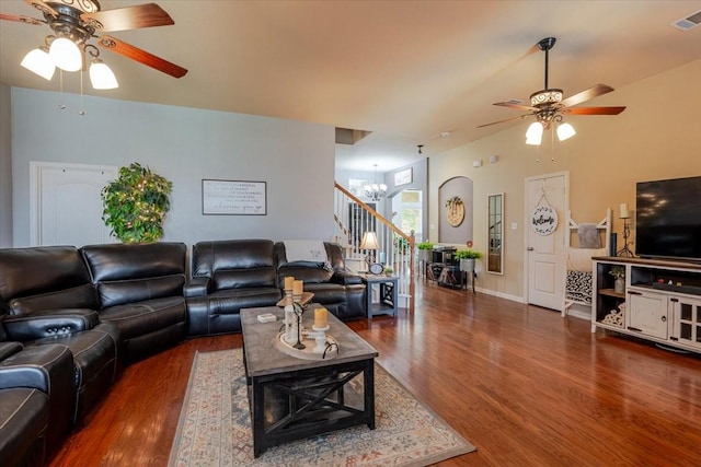 living room featuring ceiling fan, wood finished floors, and a chandelier