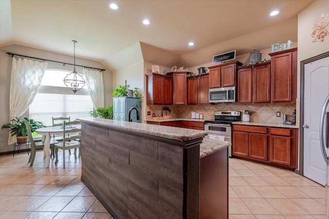 kitchen featuring appliances with stainless steel finishes, vaulted ceiling, backsplash, recessed lighting, and light tile patterned floors