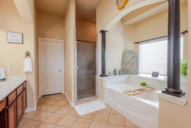 full bath featuring ornate columns, a shower stall, a garden tub, and tile patterned floors