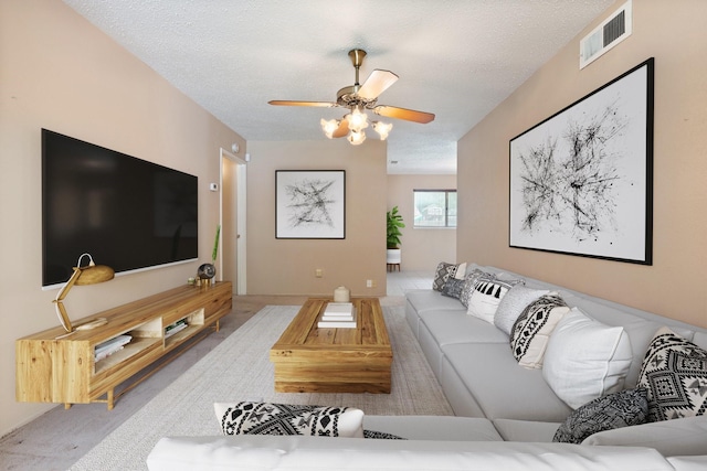 720 Oceanview Dr, Dallas, TX 75232 - living area with a ceiling fan, a textured ceiling, and carpet