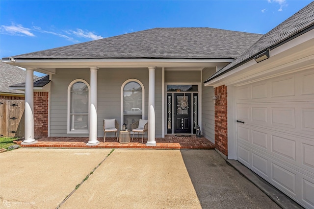 9011 Royal Lodge Ct, Shreveport, LA 71115 - property entrance featuring a shingled roof, brick siding, covered porch, a garage, and driveway