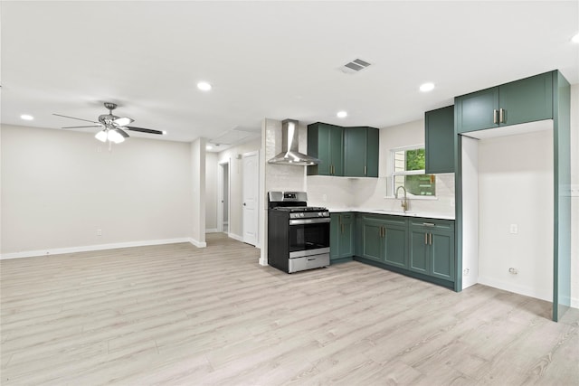 5101 Penrod Ct, River Oaks, TX 76114 - kitchen featuring gas range, wall chimney range hood, green cabinetry, light wood finished floors, and light countertops