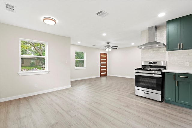 5101 Penrod Ct, River Oaks, TX 76114 - kitchen featuring stainless steel gas range, green cabinetry, wall chimney exhaust hood, healthy amount of natural light, and recessed lighting
