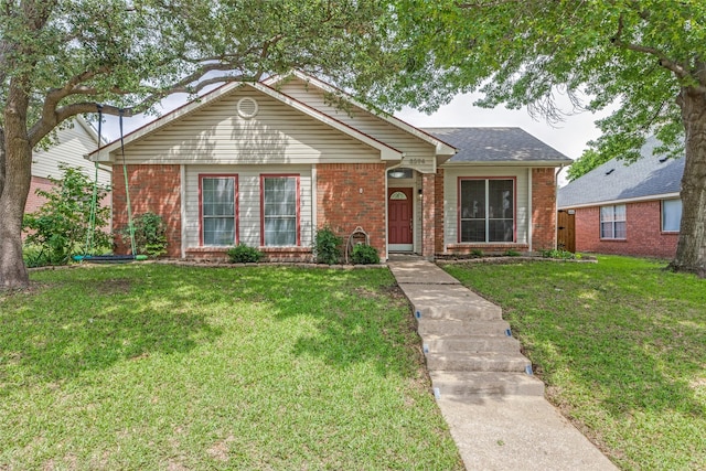ranch-style home with brick siding and a front yard