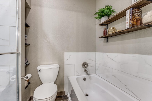 full bath with toilet, a garden tub, a textured wall, and a shower with door