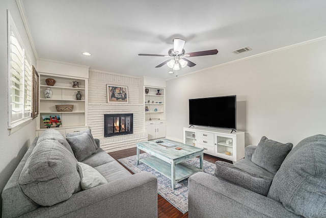 5816 Whitman Ave, Fort Worth, TX 76133 - living room featuring dark wood-style floors, a ceiling fan, a fireplace, ornamental molding, and recessed lighting