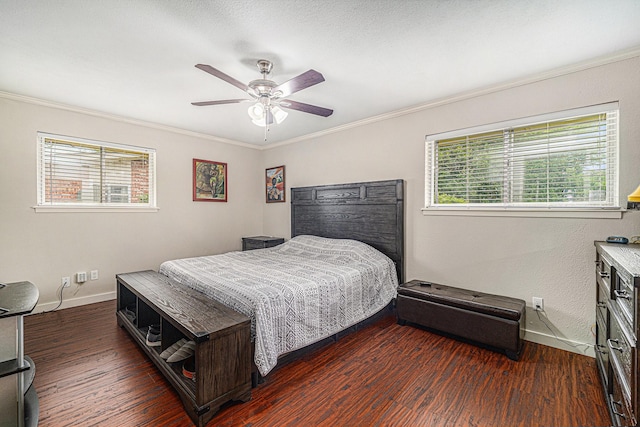 bedroom with ornamental molding, multiple windows, wood finished floors, baseboards, and a ceiling fan