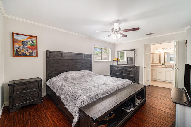 bedroom featuring wood finished floors, crown molding, baseboards, ceiling fan, and connected bathroom