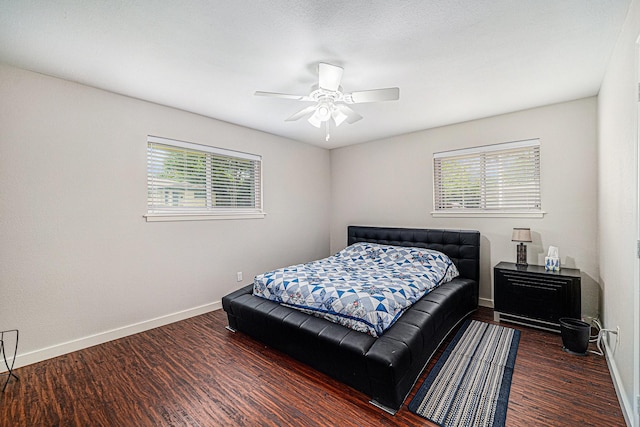 bedroom featuring baseboards, wood finished floors, and ceiling fan