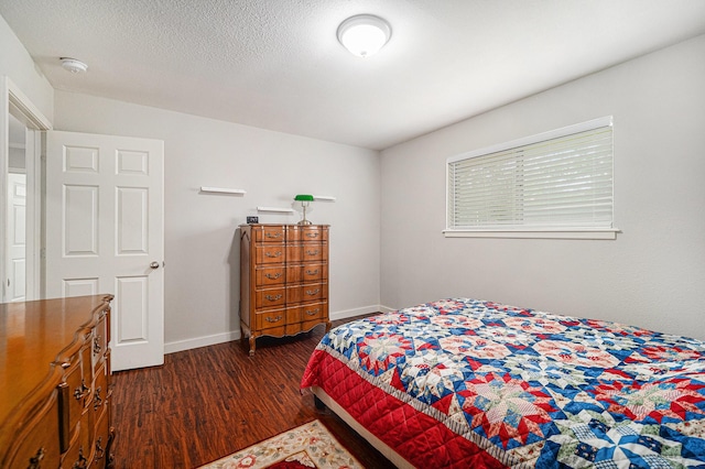 bedroom with dark wood-style flooring and baseboards