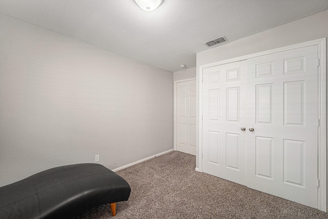 carpeted bedroom featuring baseboards and a closet