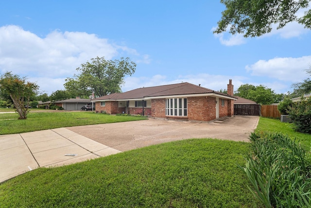 ranch-style home with a chimney, a patio, brick siding, a tile roof, and driveway