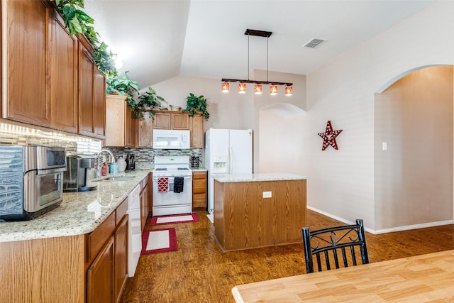 4012 Summerhill Ln, Fort Worth, TX 76244 - kitchen with white appliances, a sink, arched walkways, dark wood finished floors, and a center island