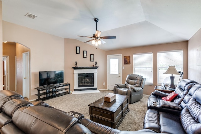 4012 Summerhill Ln, Fort Worth, TX 76244 - carpeted living area with arched walkways, lofted ceiling, a ceiling fan, and a fireplace with raised hearth