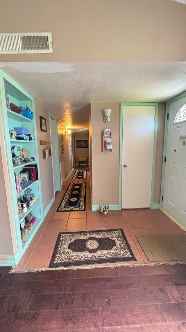 3104 Wintersmith Dr, Arlington, TX 76014 - tiled entrance foyer featuring baseboards and a textured ceiling
