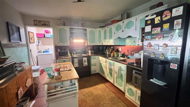 3104 Wintersmith Dr, Arlington, TX 76014 - kitchen featuring fridge with ice dispenser, black / electric stove, washer / dryer, glass insert cabinets, and a sink