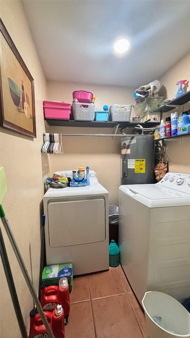 3104 Wintersmith Dr, Arlington, TX 76014 - washroom with water heater, washing machine and dryer, and tile patterned floors