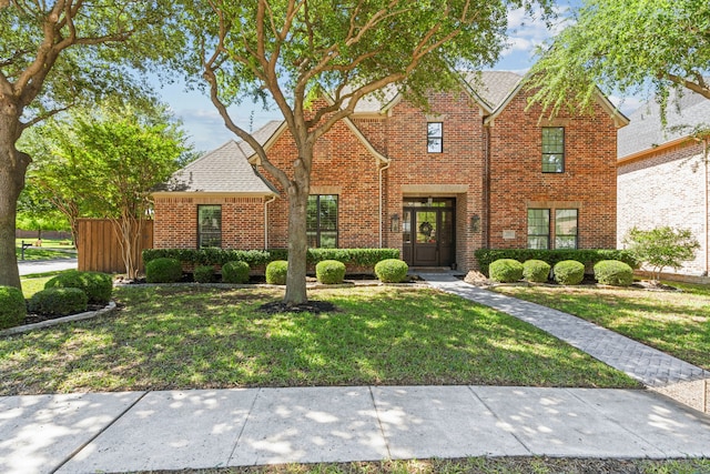 traditional-style home featuring brick siding