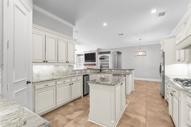 kitchen with a peninsula, tasteful backsplash, arched walkways, crown molding, and appliances with stainless steel finishes