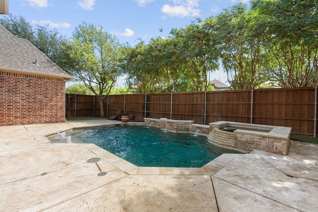 view of swimming pool featuring a fenced backyard, a patio area, and a pool with connected hot tub