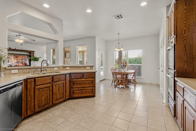 1837 Trail Dr, Rockwall, TX 75087 - kitchen with stainless steel appliances, a sink, light countertops, recessed lighting, and a chandelier