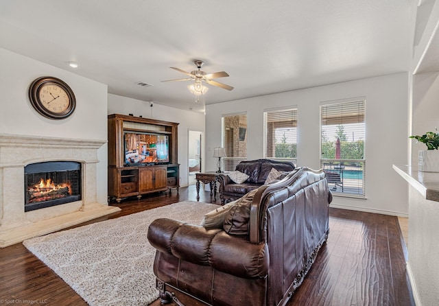 1837 Trail Dr, Rockwall, TX 75087 - living room featuring dark wood-style flooring, ceiling fan, a premium fireplace, and baseboards
