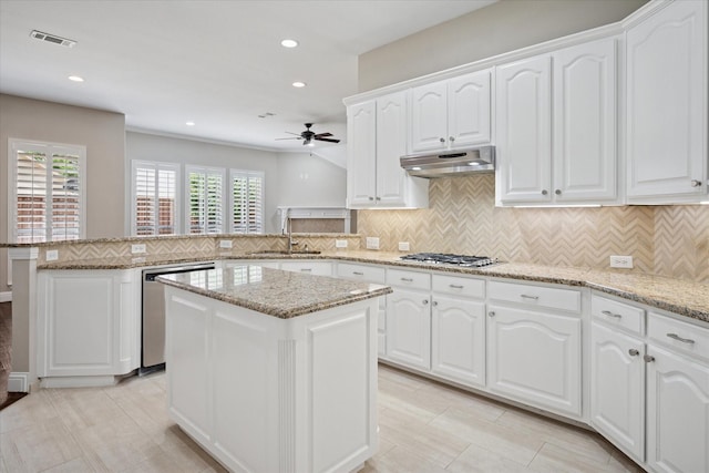 11968 Cobblestone Dr, Frisco, TX 75035 - kitchen with a sink, appliances with stainless steel finishes, a peninsula, a ceiling fan, and under cabinet range hood