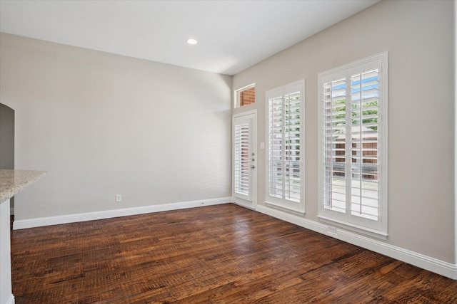 11968 Cobblestone Dr, Frisco, TX 75035 - unfurnished dining area with baseboards, dark wood-style floors, arched walkways, and recessed lighting