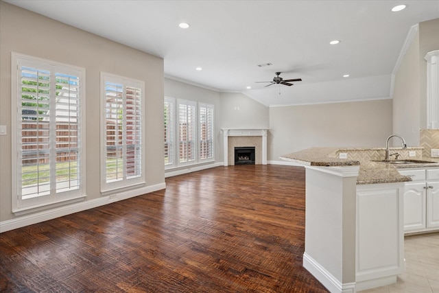 11968 Cobblestone Dr, Frisco, TX 75035 - unfurnished living room with a sink, a ceiling fan, a fireplace, crown molding, and recessed lighting
