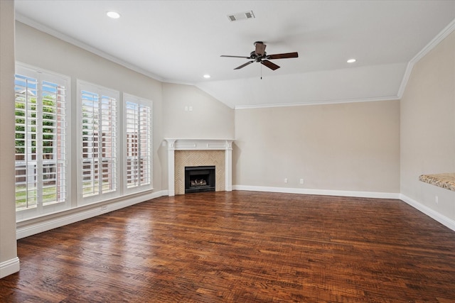 11968 Cobblestone Dr, Frisco, TX 75035 - unfurnished living room with ceiling fan, ornamental molding, a tiled fireplace, wood finished floors, and vaulted ceiling