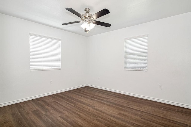 1021 Pangburn St, Grand Prairie, TX 75051 - empty room with dark wood-style flooring, a ceiling fan, baseboards, and plenty of natural light