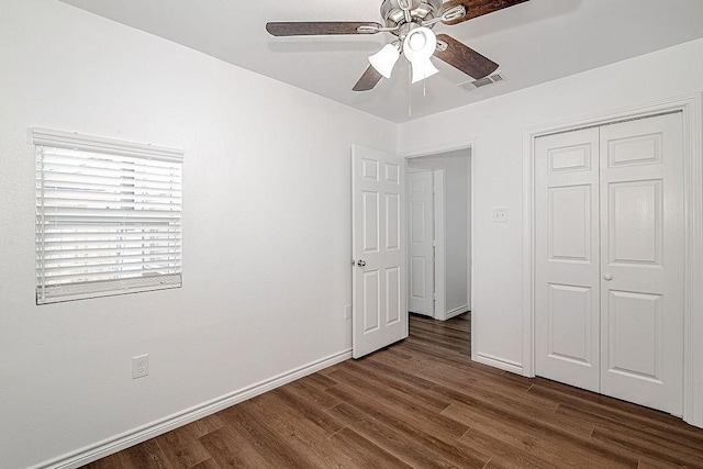 1021 Pangburn St, Grand Prairie, TX 75051 - unfurnished bedroom with dark wood finished floors, baseboards, a closet, and a ceiling fan