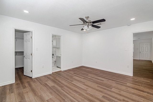 1021 Pangburn St, Grand Prairie, TX 75051 - unfurnished bedroom with a spacious closet, wood finished floors, baseboards, recessed lighting, and a closet