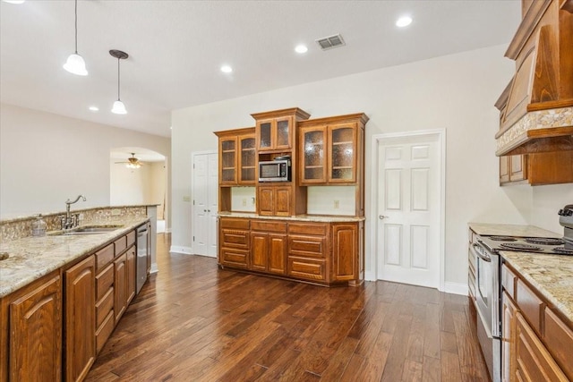 3439 Willow Branch Rd, Mcgregor, TX 76657 - kitchen featuring stainless steel appliances, a sink, brown cabinets, premium range hood, and dark wood-type flooring
