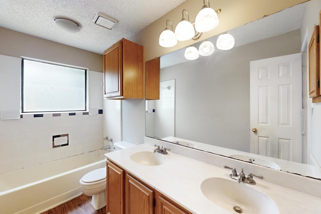 1523 Allen Dr, Cedar Hill, TX 75104 - full bathroom with toilet, wood finished floors, double vanity, and a textured ceiling