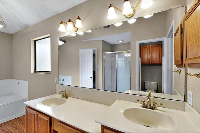 1523 Allen Dr, Cedar Hill, TX 75104 - bathroom featuring a shower stall, double vanity, a garden tub, toilet, and wood finished floors