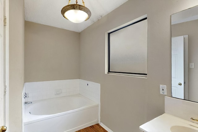 1523 Allen Dr, Cedar Hill, TX 75104 - bathroom with a bath, wood finished floors, baseboards, and vanity