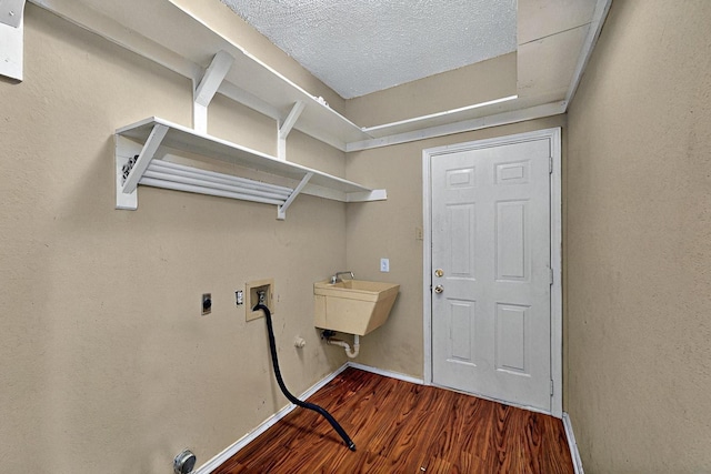 1523 Allen Dr, Cedar Hill, TX 75104 - washroom featuring hookup for a washing machine, wood finished floors, baseboards, hookup for an electric dryer, and a textured ceiling