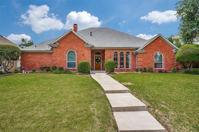 3336 Sage Brush Trl, Plano, TX 75023 - view of front of property featuring brick siding, a front yard, a chimney, and roof with shingles