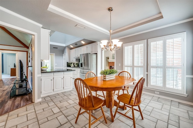 3336 Sage Brush Trl, Plano, TX 75023 - dining area featuring a chandelier, a tray ceiling, crown molding, light stone finish floors, and baseboards
