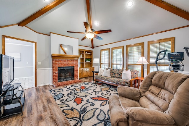 3336 Sage Brush Trl, Plano, TX 75023 - living room featuring wood finished floors, ceiling fan, a wainscoted wall, crown molding, and healthy amount of natural light