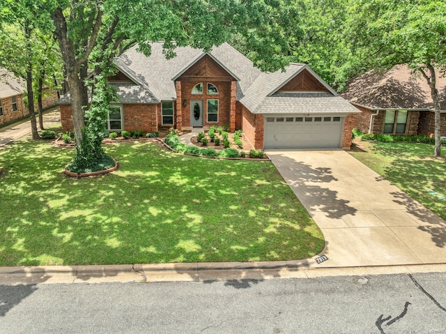 traditional-style house featuring concrete driveway, an attached garage, a front yard, brick siding, and roof with shingles