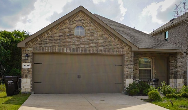 3128 Bettin Dr, Mesquite, TX 75126 - view of front of home with brick siding, driveway, a garage, roof with shingles, and stone siding