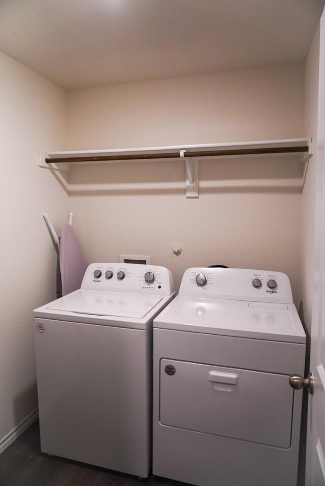 3128 Bettin Dr, Mesquite, TX 75126 - laundry room featuring washing machine and clothes dryer, dark wood-type flooring, and baseboards
